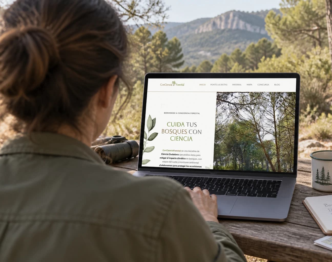 Web de ConCiencia Forestal presentada en un portátil en plena naturaleza